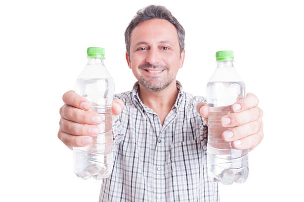 istock Man giving or offering two bottles of cold water 483684194