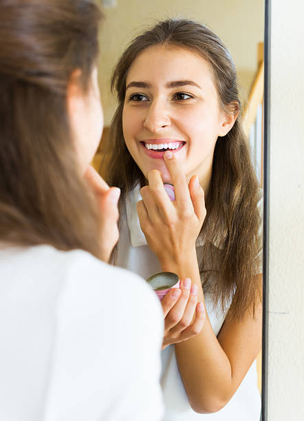 istock Teenager applying lipstick 483687554