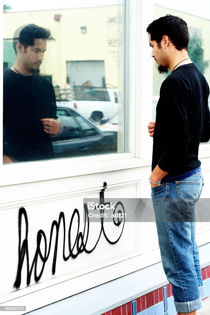 introspection man looking into reflection in glass, the word "honest" written under him. Contemplation Stock Photo
