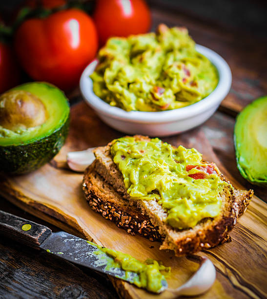 istock Guacamaole with bread and avocado on rustic wooden background 483688139