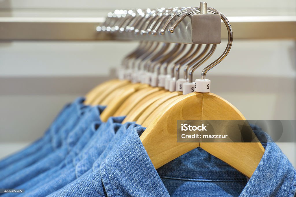 Jeans shirts on the hangers Jeans shirts on the hangers in the clothing store Boutique Stock Photo