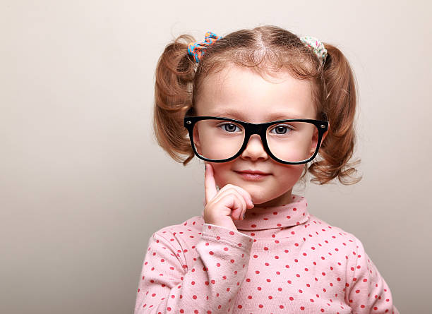 istock Thinking kid girl in glasses looking happy on copy space 483689685
