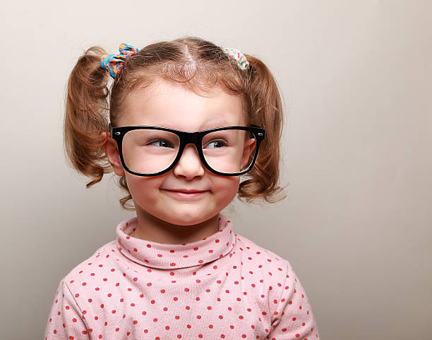istock Fun kid girl in glasses looking on empty copy space 483691409