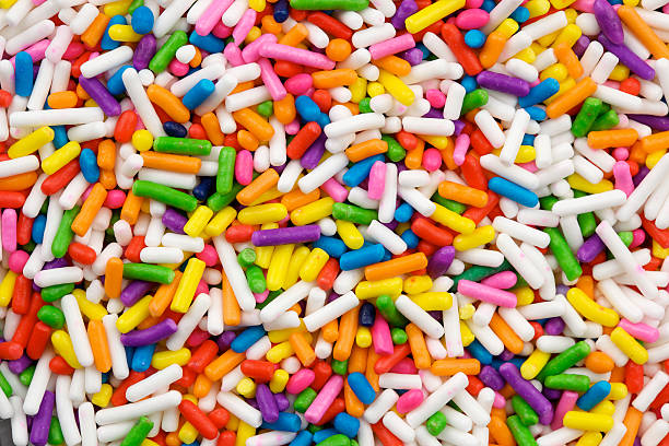 cake sprinkles Macro studio image of multi-colored cake sprinkles, also known as "jimmies". cake texture stock pictures, royalty-free photos & images