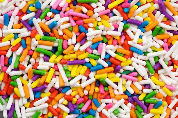 Macro studio image of multi-colored cake sprinkles, also known as "jimmies".