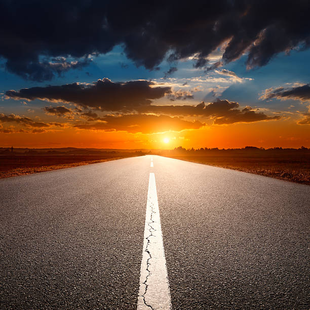 istock Driving on an empty asphalt road at sunset 483691633