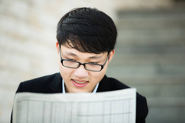 istock Young businessman reading newspaper 483691857