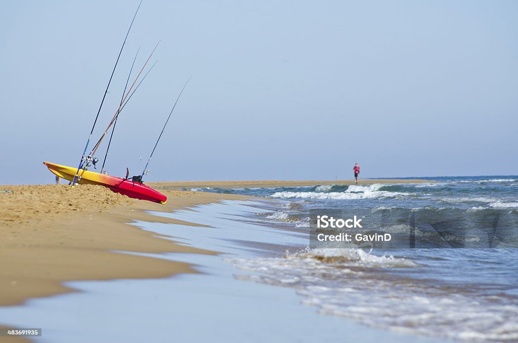 Отдаленный пляж сцена с каяк и рыболовства прутков - Стоковые фото Каяк роялти-фри