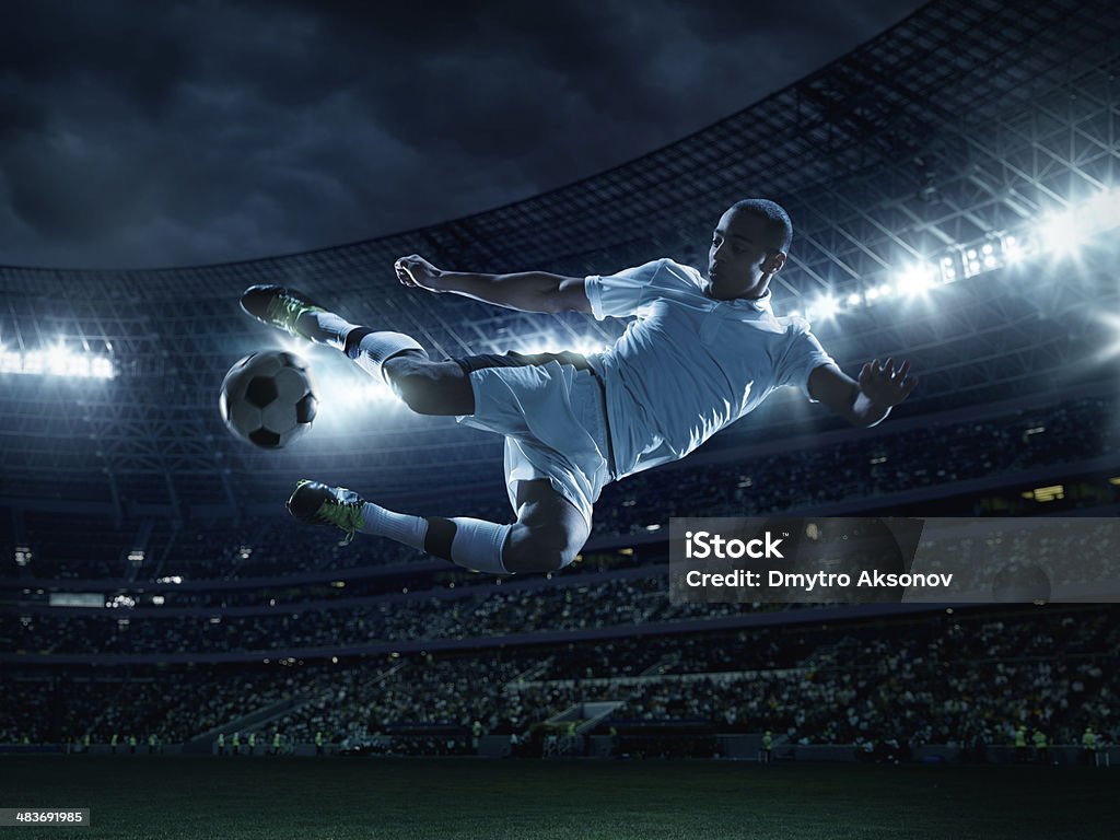 Soccer Player Kicking Ball Soccer Player Kicking Ball in mid-air Soccer Stock Photo