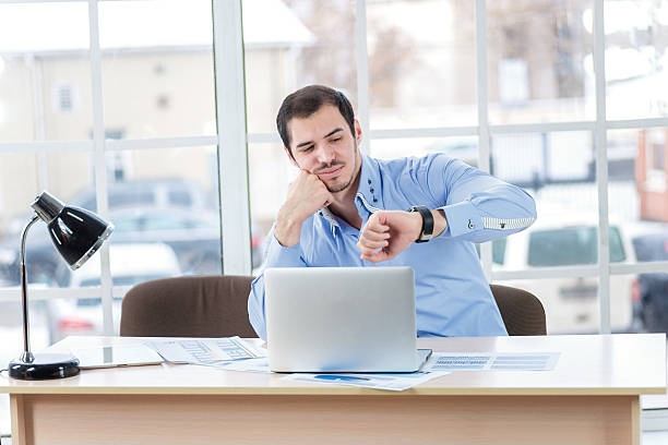istock Long working hours. Tired businessman resting a laptop and looki 483697728