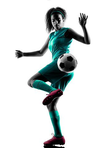 one teenager girl child  playing soccer player in silhouette isolated on white background