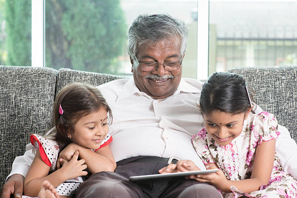 istock Grandfather and granddaughter using modern technology 483698464