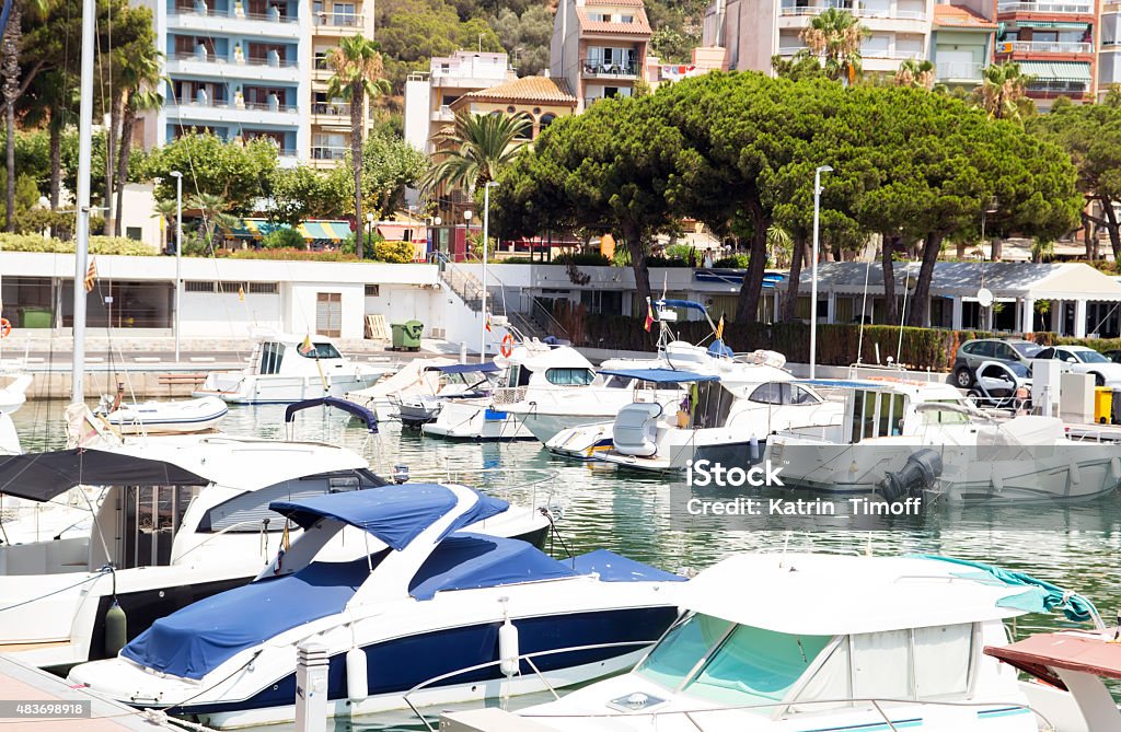 Boats at city pier Boats at city pier with urban view in sunny day 2015 Stock Photo