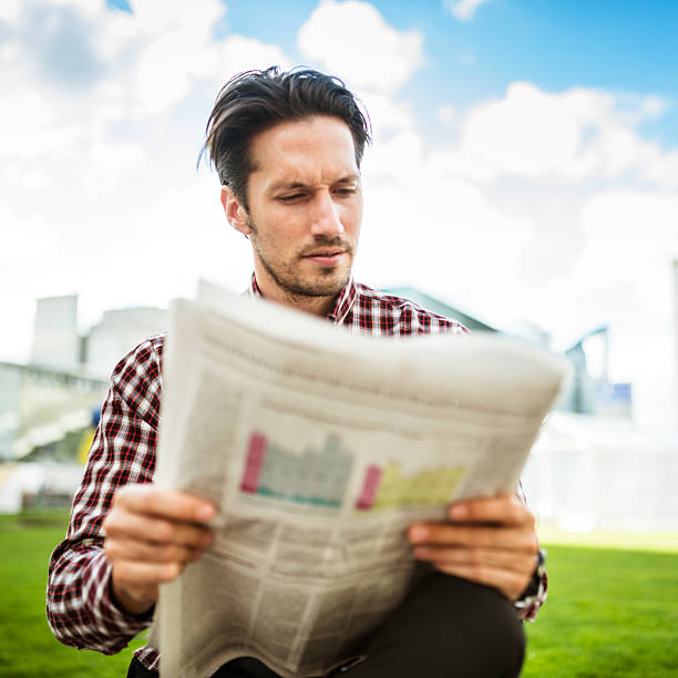 istock young adult entrepreneur reading the newspaper 483701606