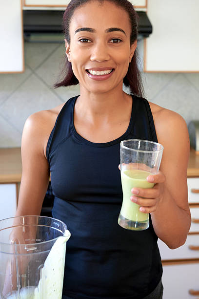 istock woman holding a smoothie glass 483703204
