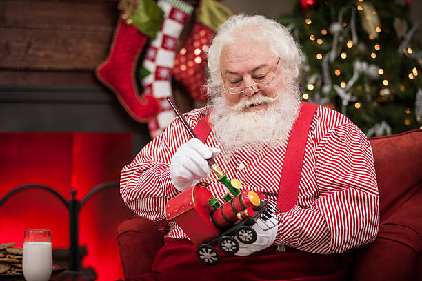 istock Real Santa Claus Painting Toy Train 483705782