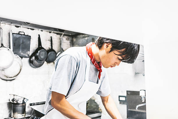 Chef working in the kitchen. Japanese chef working in the kitchen. japanese chef stock pictures, royalty-free photos & images