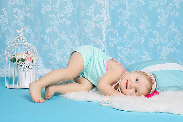 istock girl lying on floor studio portrait 483708700