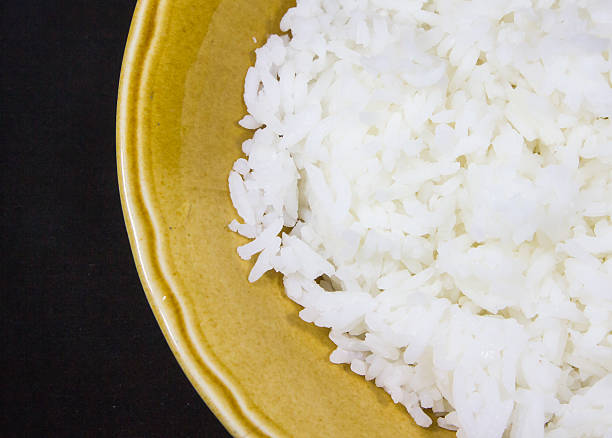 rice in yellow bowl stock photo