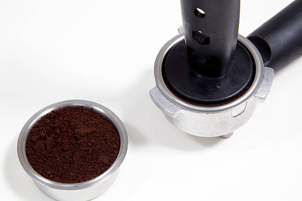 istock Portafilter filled with ground coffee on a white background 483711812