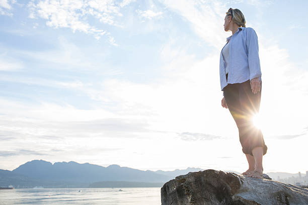 istock Woman looks over her shoulder towards mountains 483713064