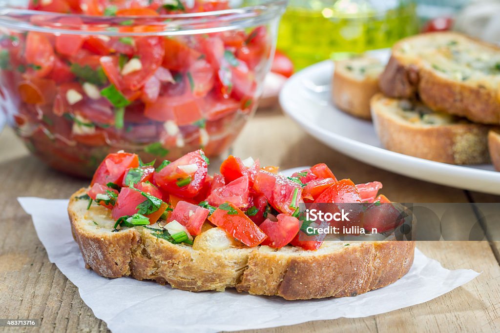 Bruschetta with tomatoes, herbs and oil on garlic cheese bread Bruschetta with tomatoes, herbs and oil on toasted garlic cheese bread Bread Stock Photo