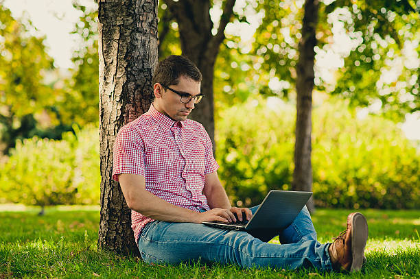 istock Young man Working in the Park with Laptop Computer 483714280