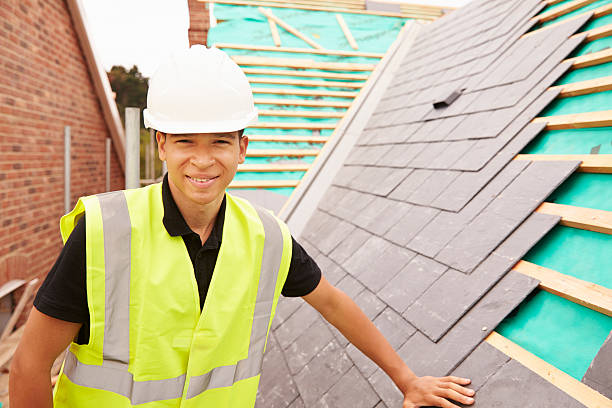 istock Construction Worker On Building Site Laying Slate Tiles 483717682