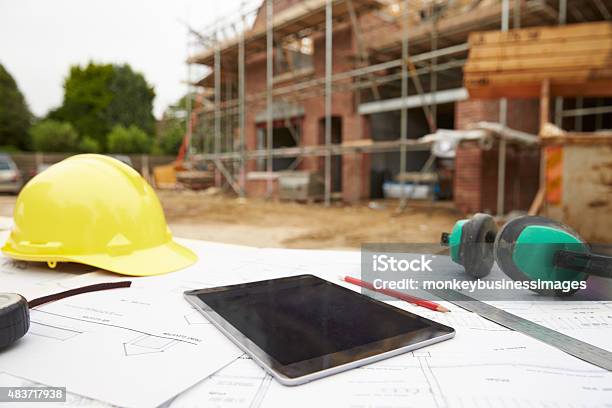 Close Up Of Plans And Digital Tablet On Building Site Stock Photo - Download Image Now