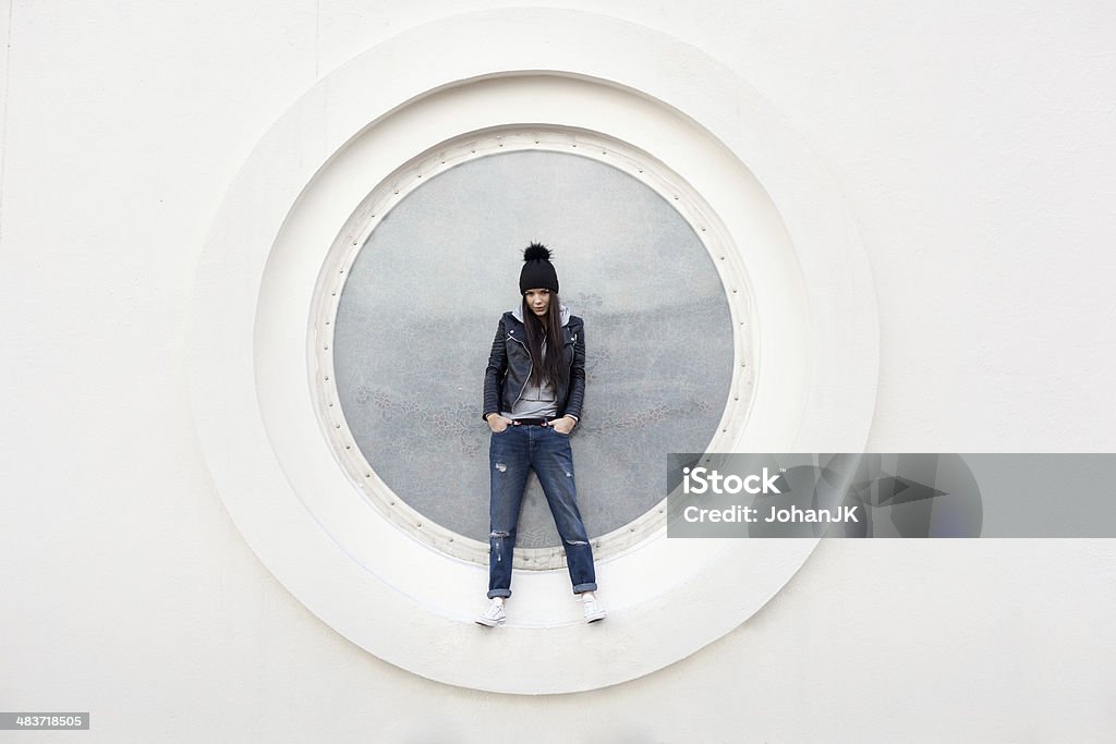 portrait of a beautiful girl hipster Portrait of a beautiful girl hipster. Young woman posing against a wall in the shape of a circle. Outdoors, lifestyle. Adult Stock Photo