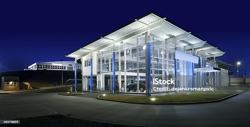 Car Salon Exterior of a modern car salon, night scene. Lighting Equipment Stock Photo