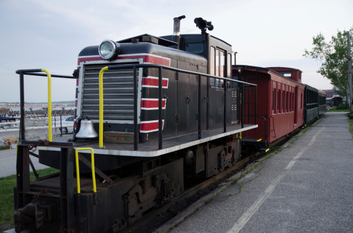 a locomotive with a few wagons resting on its rail outside