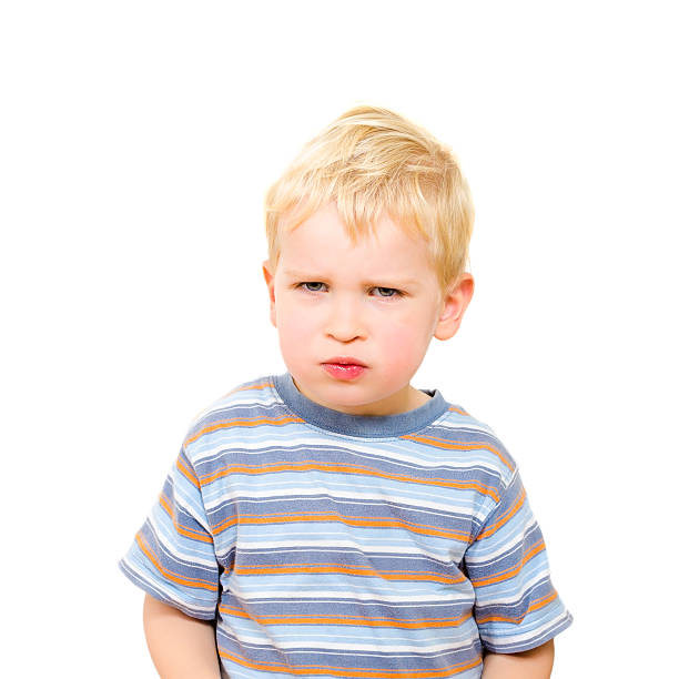 istock Angry and serious beautiful boy isolated on white 483720255