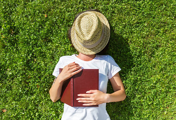 Girl sleep on the Field with book