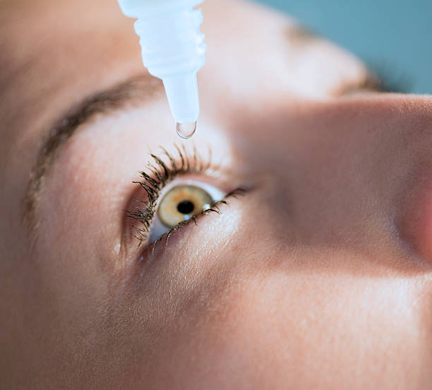 istock Eyedropper releasing fluid into an eye 483720785