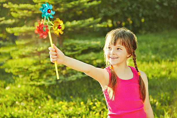 istock girl with pinwheel 483720963