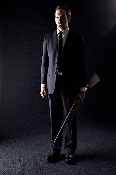 istock Youthful Gangster Carrying A Semi-automatic Shotgun 483722590