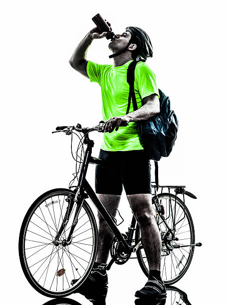 istock man bicycling mountain bike drinking silhouette 483724113