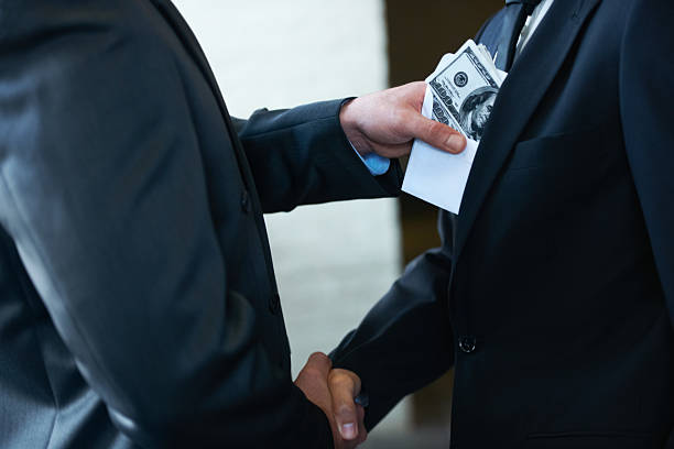 He's a rotten egg in the corporate world Two corporate businessmen shaking hands while one man places money in the other&amp;amp;#039;s pockethttp://195.154.178.81/DATA/i_collage/pi/shoots/781058.jpg corruption photos stock pictures, royalty-free photos & images