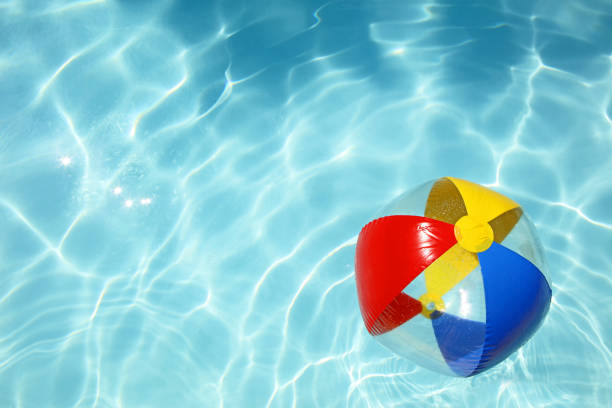 istock Colorful Beach Ball Floating on Water in a Swimming Pool 483725944