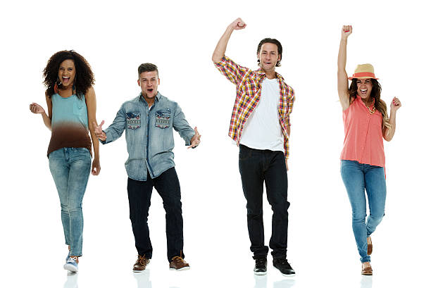 istock Cheerful four friends cheering and walking 483726216