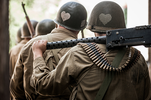 Vintage photograph of authentic World War II army soldier in battle reenactment.