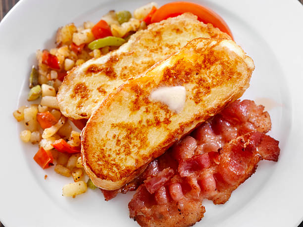 Brioche French Toast with Maple Syrup Brioche French Toast with Maple Syrup, Bacon and Hashbrowns-Photographed on Hasselblad H3D-39mb Camera french toast bacon bread butter stock pictures, royalty-free photos & images