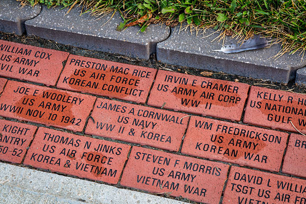 Sedalia, MO, USA - August 3, 2015: Engraved veteran memory bricks in sidewalk pavement surrounding Pettis County Courthouse in historic downtown of Sedalia. Missouri.