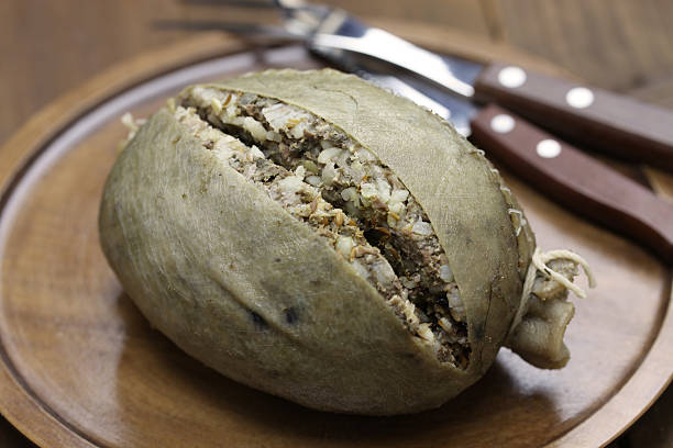homemade haggis, scotland food homemade haggis, scotland food isolated on wooden background haggis stock pictures, royalty-free photos & images