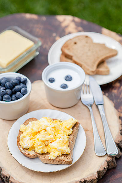 Breakfast in the garden: scrambled eggs on toast and yogurt