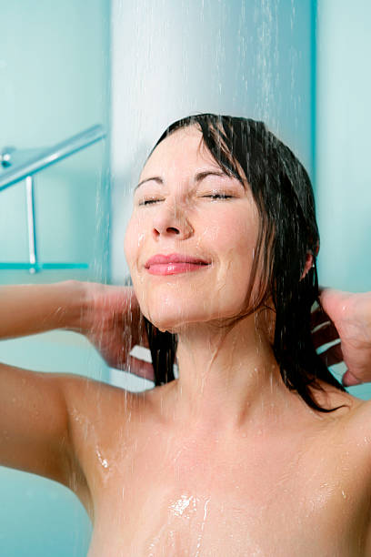 istock Young woman in shower 483735626