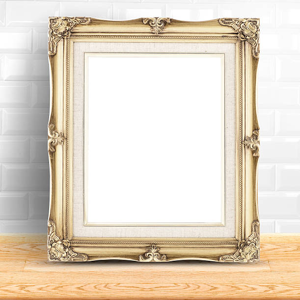Golden Vintage photo frame at white ceramic tiles wall