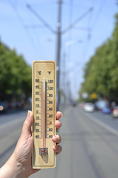 istock thermometer in hand on the street 483739778