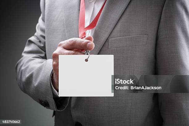 Businessman Holding Blank Id Badge Stock Photo - Download Image Now - Security Pass, Badge, Men